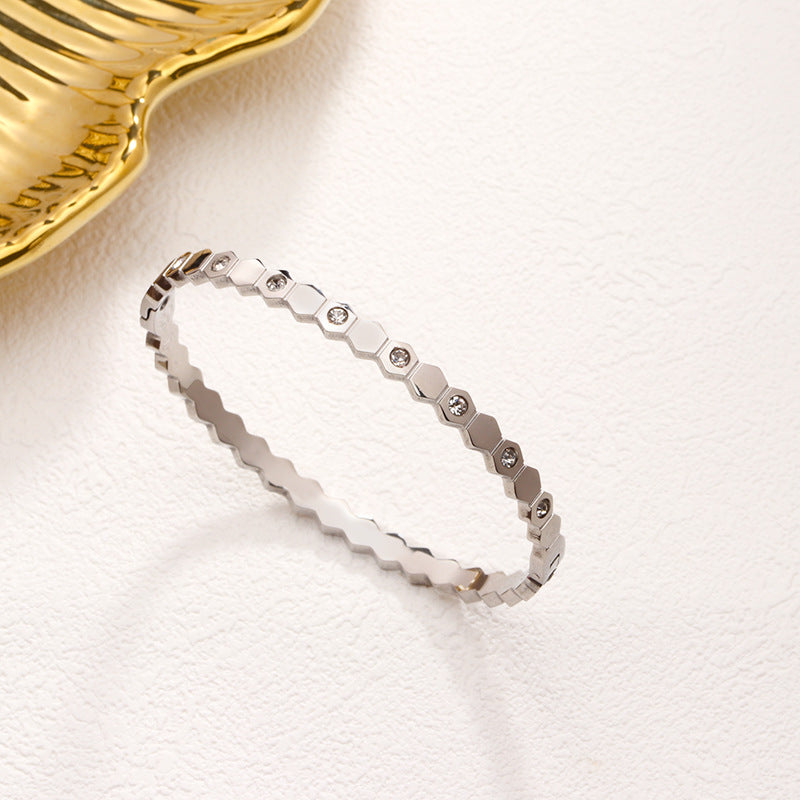 Silver bracelet with geometric design on a light background