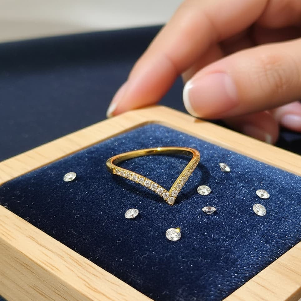 Gold ring with diamonds on a blue cushion in a wooden box