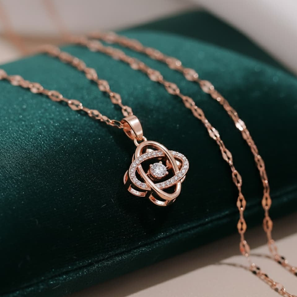 Rose gold necklace with a diamond pendant on a green cushion