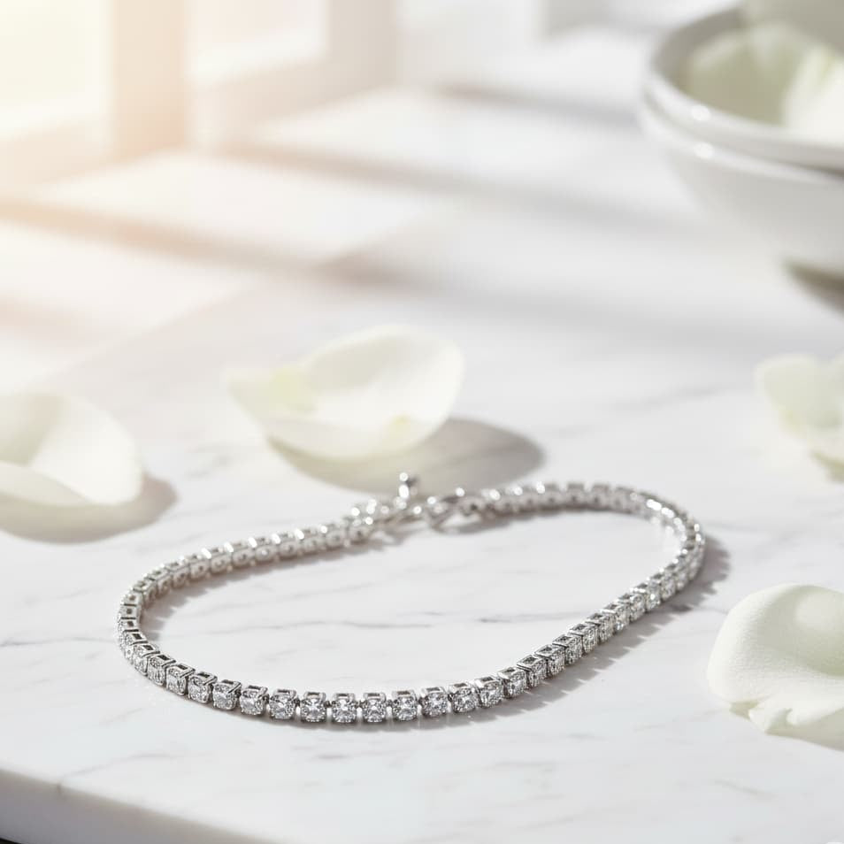 Silver bracelet on a white surface with white flowers