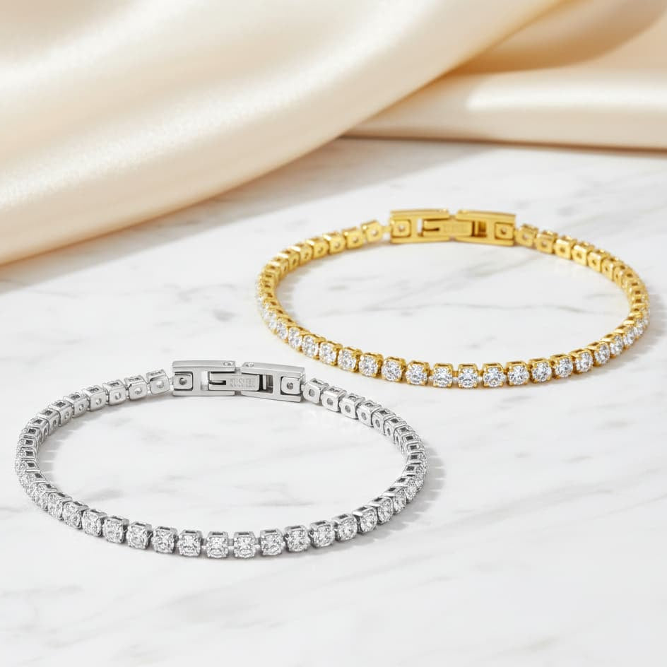 Gold and silver bracelets on a soft fabric background