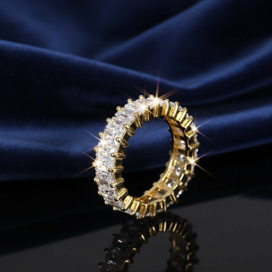 Gold and diamond ring on a blue fabric background