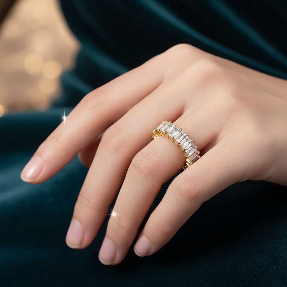 Gold ring with diamonds on a hand against a dark background